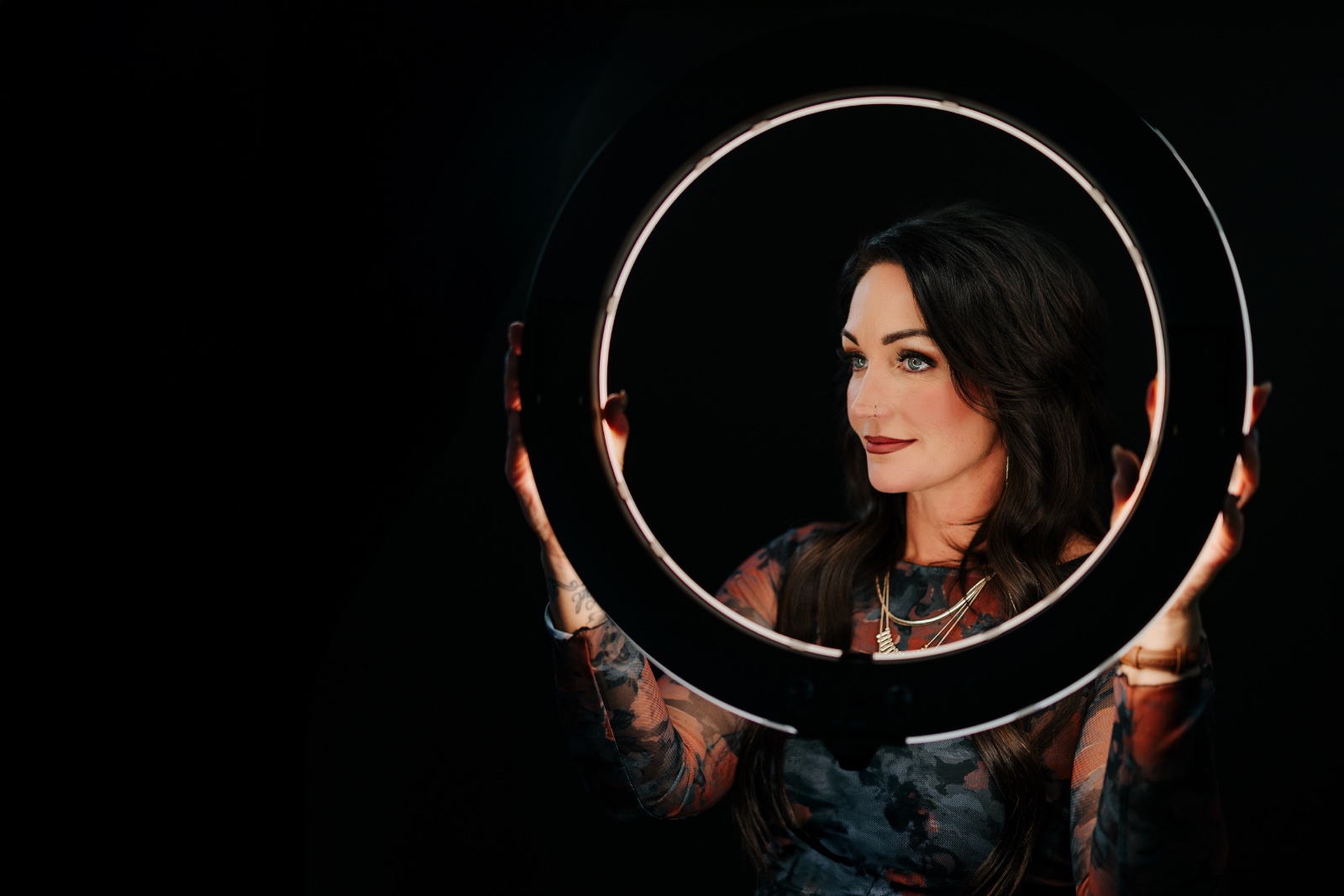 Jodi Sodini holding a ring light